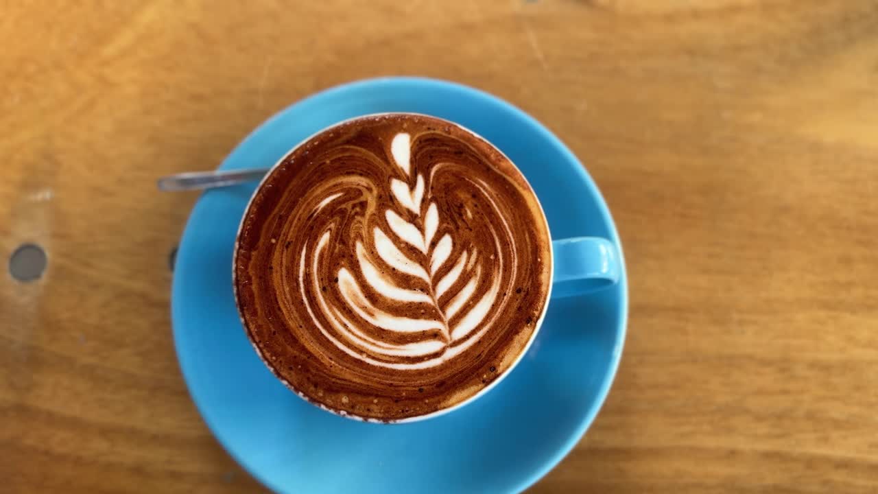 Coffee latte art, cappuccino milk caffeine drink, beautiful presented inside restaurant