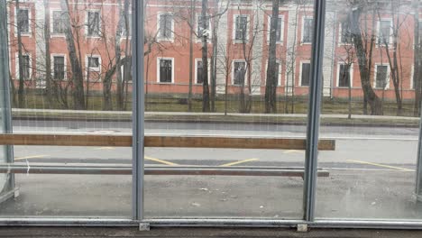 empty glass and metal bus stop shelter, pushkin, saint petersburg, russia.