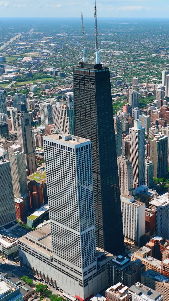 Aerial view sunny day in downtown Chicago, Illinois, USA. 875 North Michigan Avenue. Vertical video