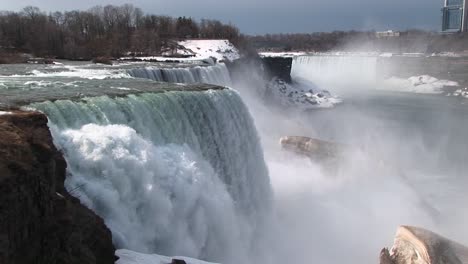 a look from the top of niagara falls to the snow and mist in the distance