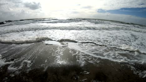 algae foam in storm on the beach, sandy beach with waves, north sea, jütland, sondervig, denmark, 4k