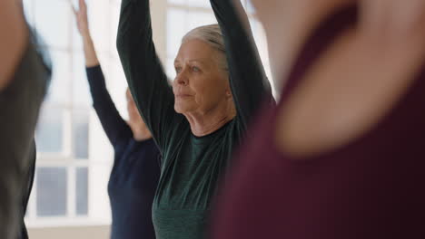 Yoga-Kurs-Mit-Gesunden,-Reifen-Frauen,-Die-Gebetspose-Praktizieren-Und-Entspannende-Atemübungen-Im-Fitnessstudio-Genießen