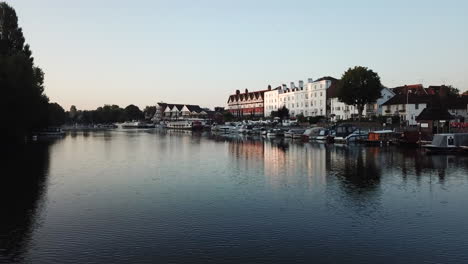 cool drone shot flying through henley bridge and then rising above the town, filmed at sunrise