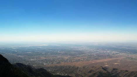 aerial drone of albuquerque, new mexico, over treetops of sandia mountains