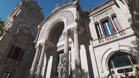 a grand historical courthouse exterior in barcelona under sunlight with ornate design