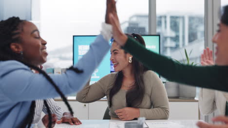 business team celebrating success with high fives during a meeting