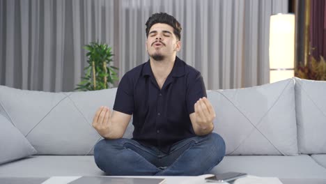 Young-man-doing-breathing-meditation.