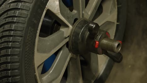 close-up of wheel in motion with the unscrewing tool