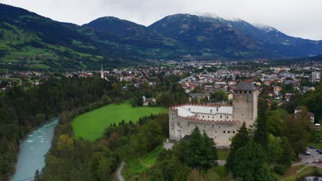 aerial view of castle bruck beside river isel in austria with town of lienz in background