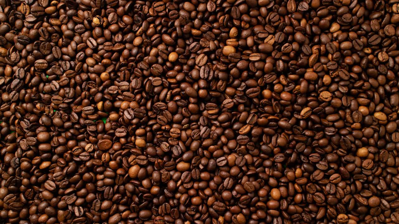 Coffee animated background. Looped video. Stop-motion animation coffee concept. Top view of freshly roasted coffee beans