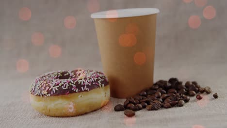 Animation-of-coffee-and-donut-over-light-spots