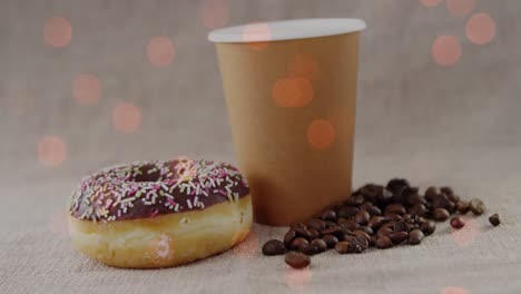 animación de café y rosquilla sobre puntos de luz