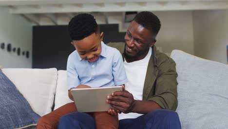 African-american-father-and-son-using-a-digital-tablet-together