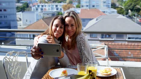 lesbian couple taking selfie in balcony 4k