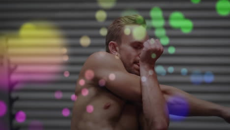 Exercising-in-gym,-shirtless-man-with-colorful-bokeh-animation-in-background