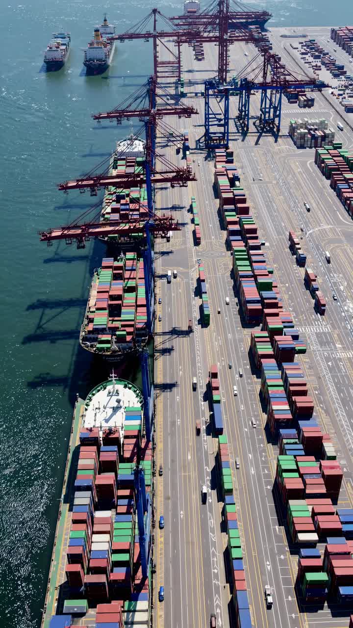 Aerial view of a bustling port with colorful shipping containers and cranes, resembling a time-lapse