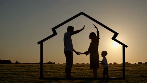 family silhouette at sunset