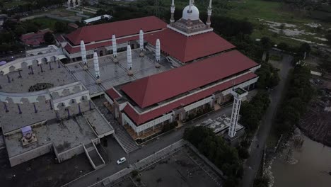 aerial view of the great mosque of central java (majt) in suset time. the mosque have some towers and have some large umbrella that is closed