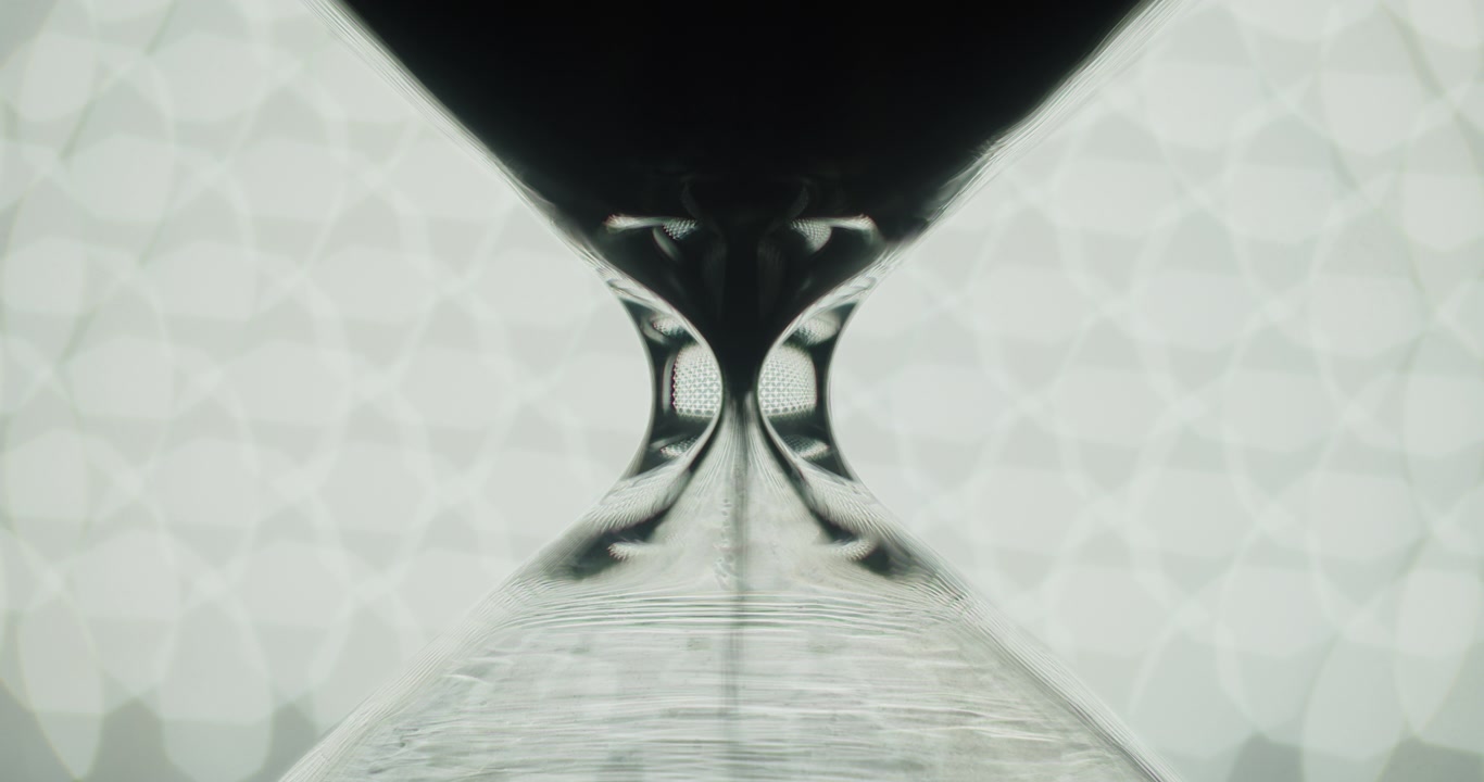 Transparent hourglass and bokeh lights.