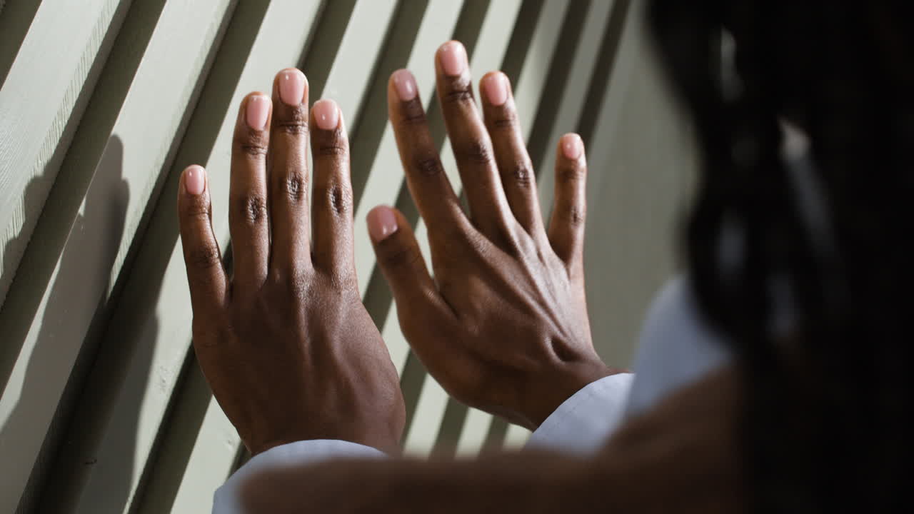 Hands Touching a Wall