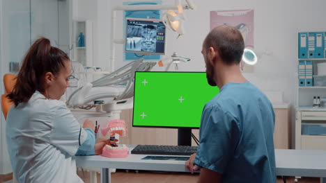 Nurse-and-dentist-examining-teeth-layout-using-green-screen