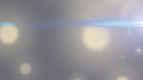 animation of flaring light beam moving over bokeh white light spots on grey background