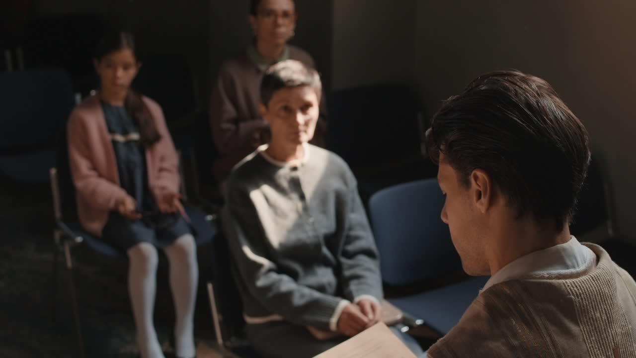 A group of people sitting in chairs indoors