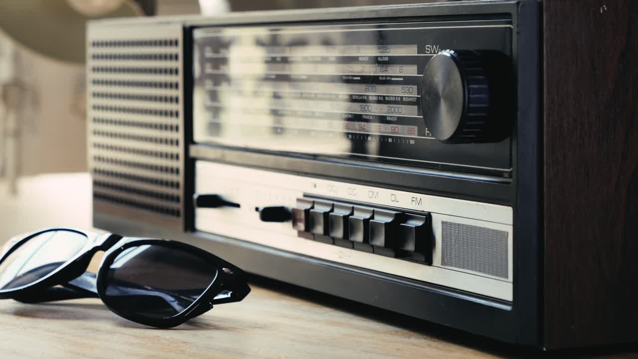 Vintage Radio and Sunglasses on a Wooden Table