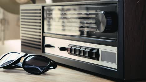 vintage radio and sunglasses on a wooden table