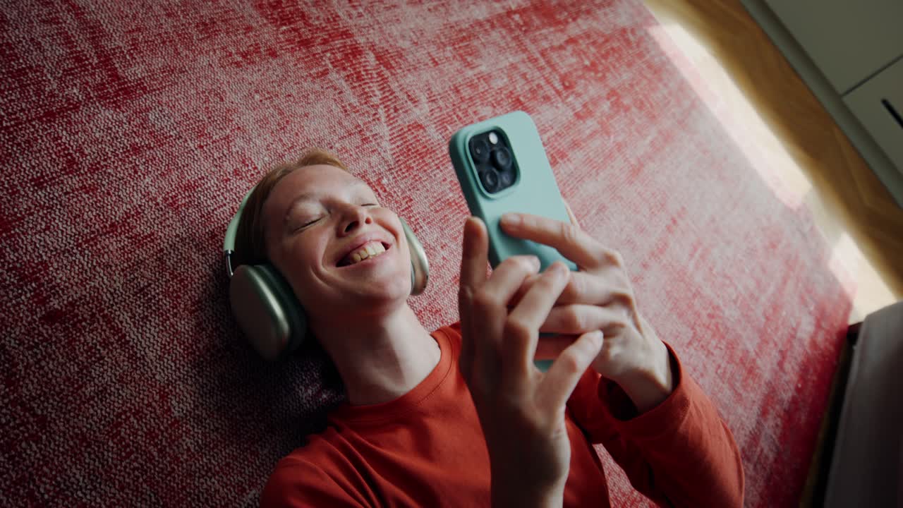 mujer relajándose en el suelo con auriculares y teléfono