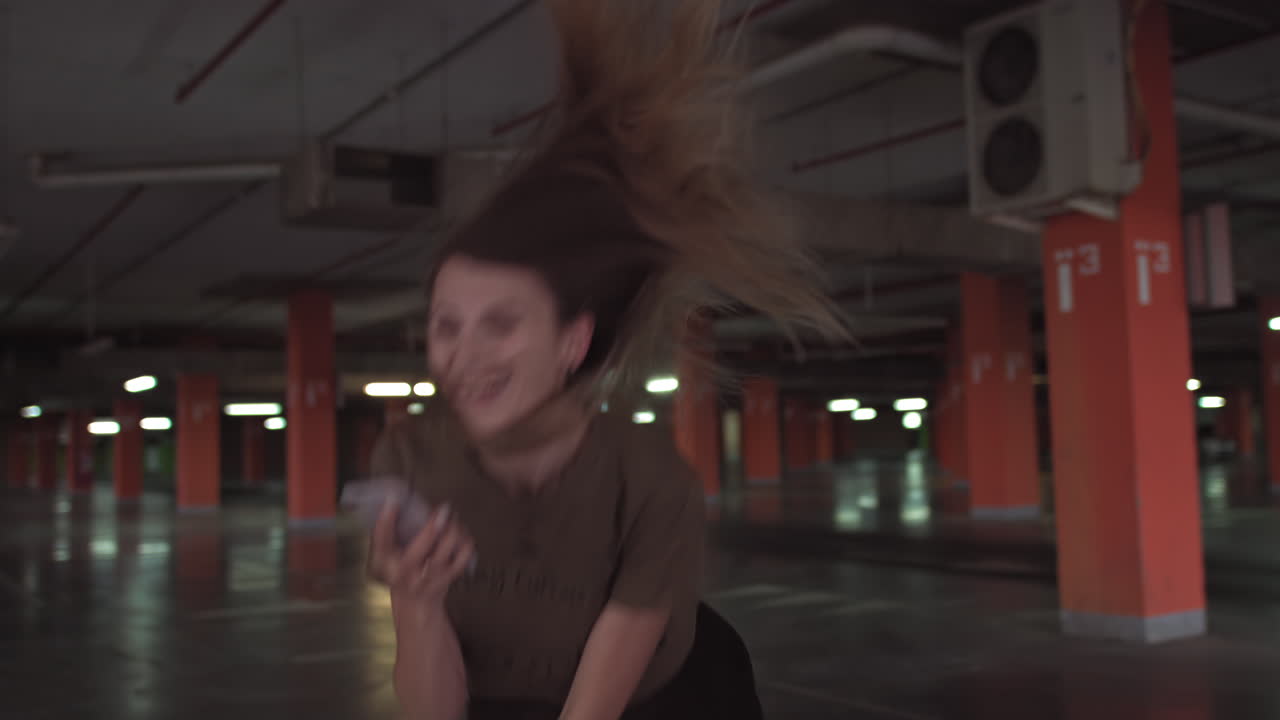 Woman walking in an empty underground parking garage