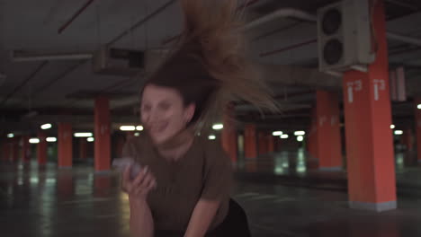 woman walking in an empty underground parking garage