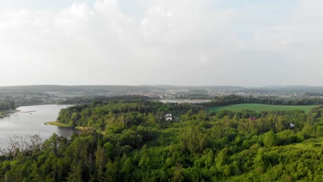 Aerial-boom-shot-of-a-green-meadow-in-pomeranian-district-in-Poland