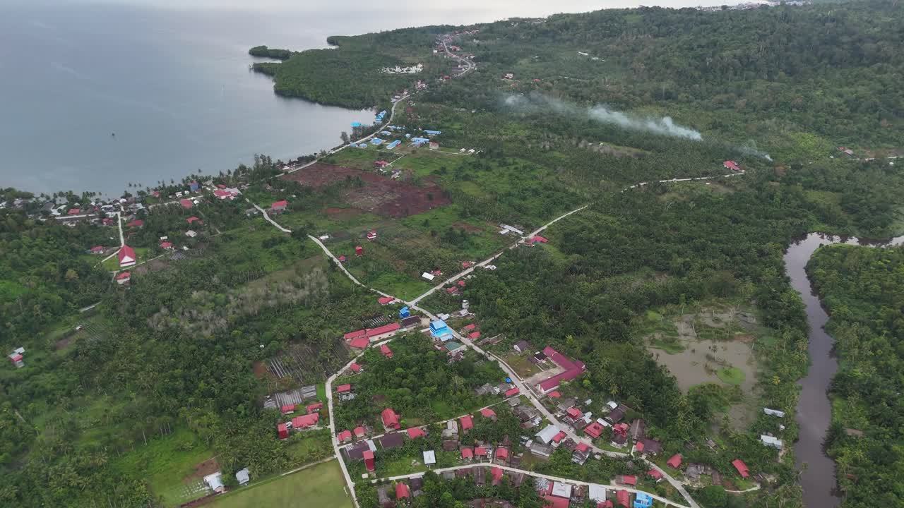 Drone aerial view of trees tropical rainforest jungle west sumatra Mentawai Islands Regency indonesia small village