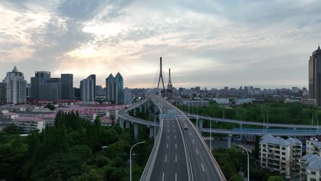 drone aerial view of traffic and highway in the city during sunset