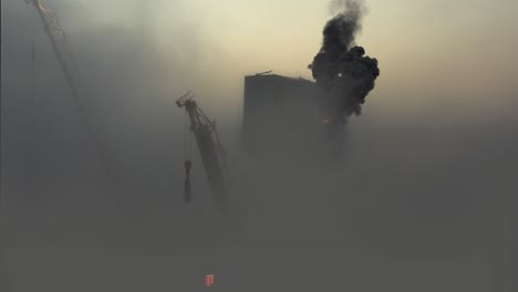 high-rise building fire in fog