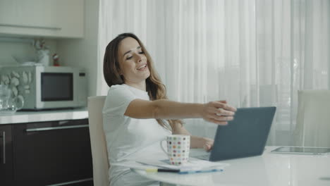 young woman have break in computer work at home. happy person stretching