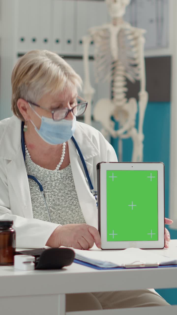 Doctor showing tablet with green screen