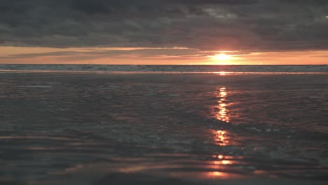 waves in slow motion in front of the sunset on sylt