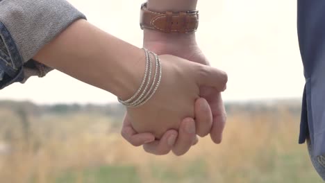 a couple holding hands in a romantic fashion