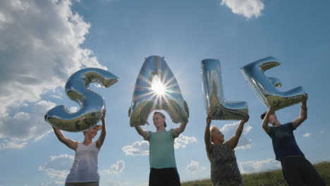 several people hold balloons in the form of letters make up the word sale 4k video