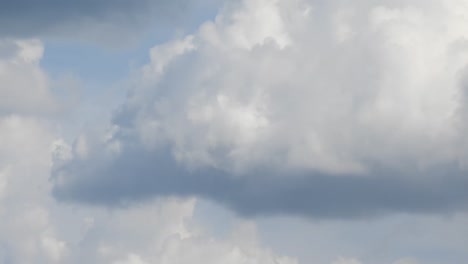 time lapse with white clouds forming on sunny blue sky
