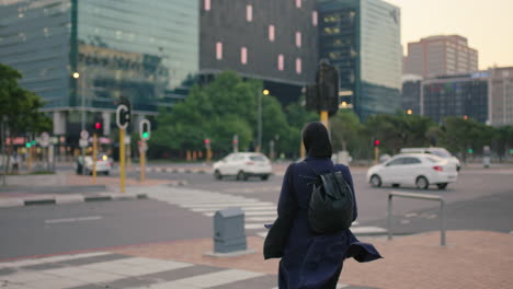 young muslim business woman intern standing in urban city street waiting busy evening traffic wearing hajib headscarf