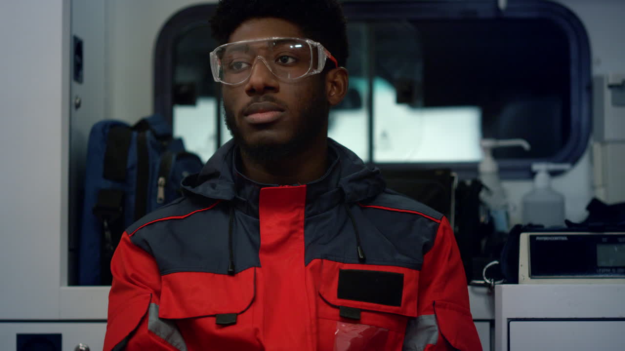 Paramedic driving in ambulance vehicle for 911 call. Medic feeling tired