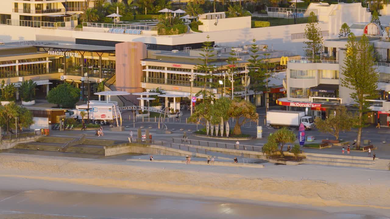 Aerial view of Gold Coast boardwalk at sunrise, capturing morning light, beach, and urban landscape. Calm and serene atmosphere