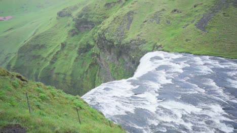 The-top-of-Dettifoss-waterfall,-surrounded-by-grass-in-Iceland---Slow-motion