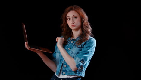 a young caucasian woman types on laptop