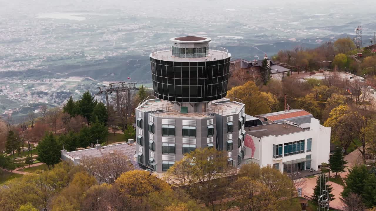 Aerial view of unique building in Tirana, Albania, surrounded by trees