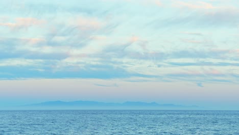 time-lapse of gran canaria seen from candelaria coastline at dusk, clouds moving