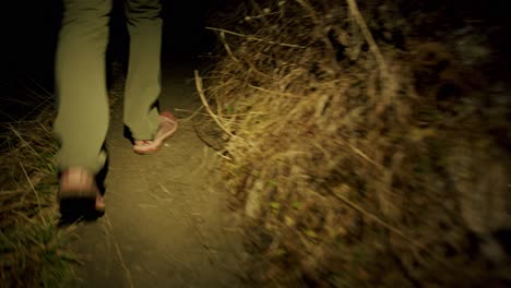 a hiker is climbing up a steep path in the dark with a head light